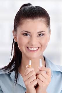 A person holding a broken cigarette  Description automatically generated