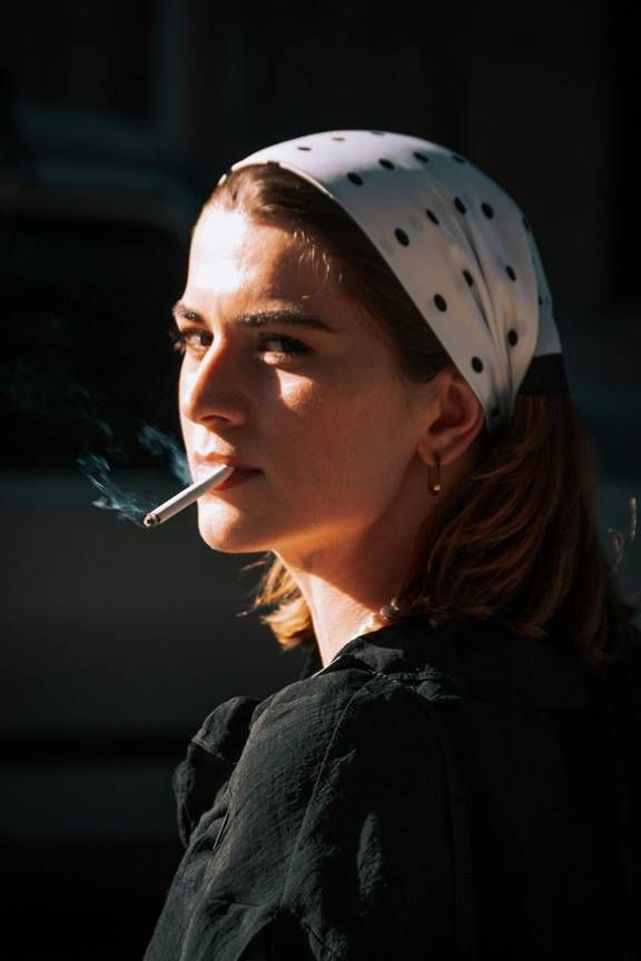 A person smoking a cigarette  Description automatically generated